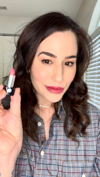 woman holding lipstick in hand